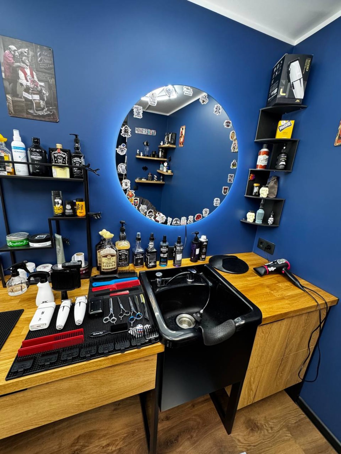 Barber station with a round illuminated mirror