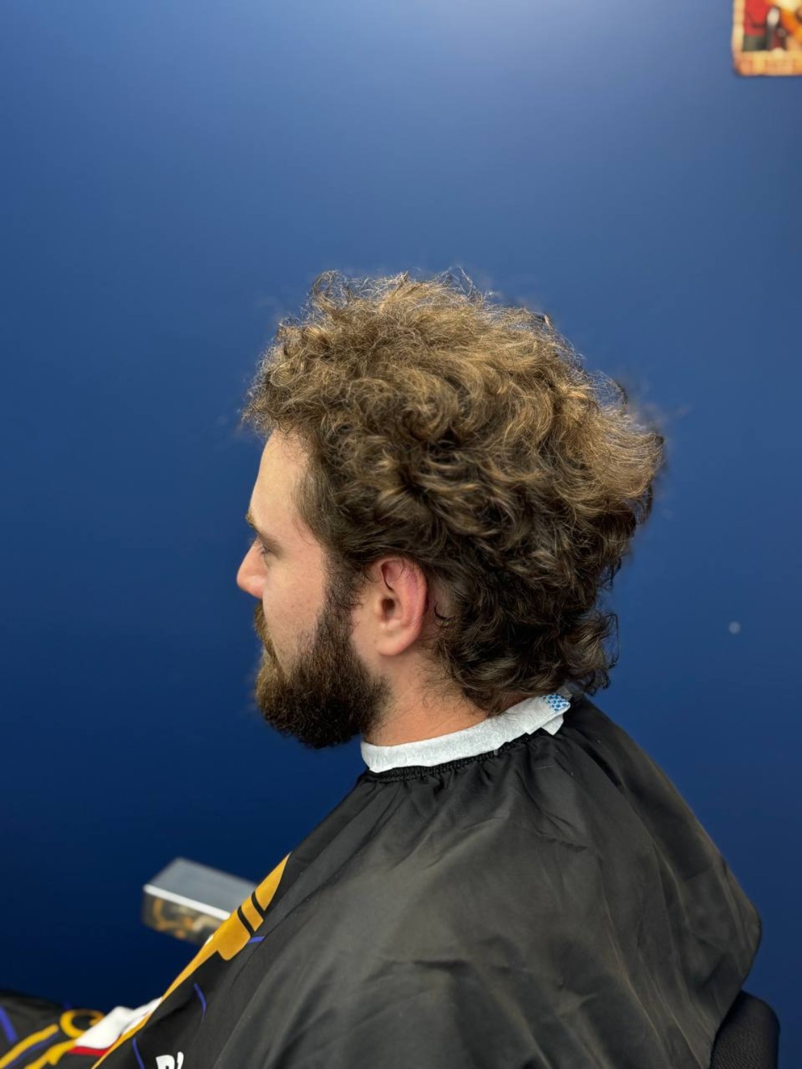 Long curly hair and beard before the service
